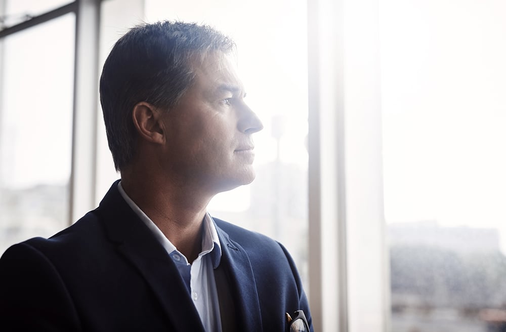 Business person thinking and reflecting on seeking a business valuation in the new year