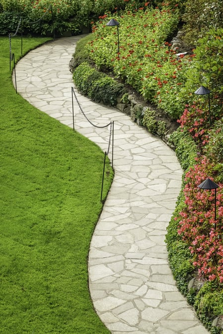 High angle view of wide stone path with S-curve in formal garden